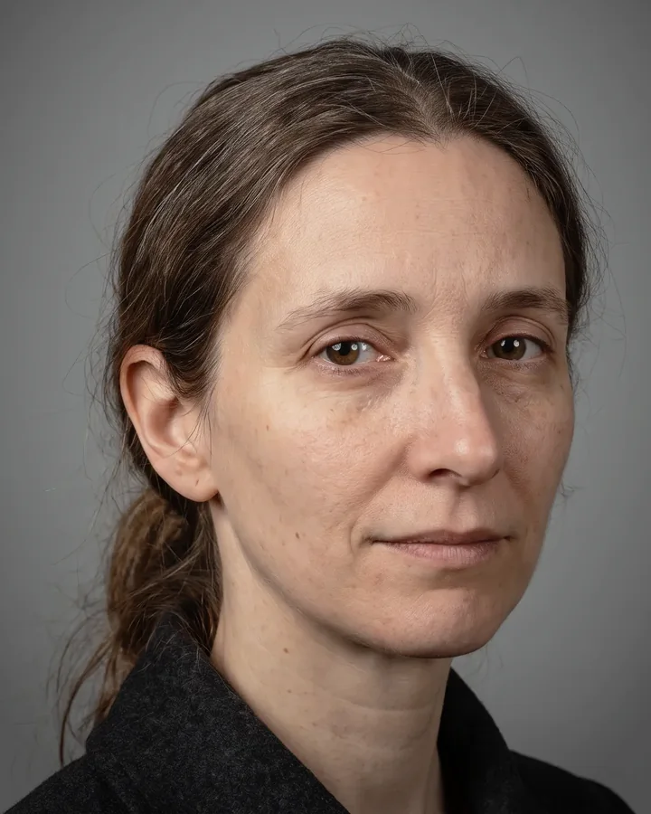 Sister Eyma, a woman with tied back hair and a level gaze